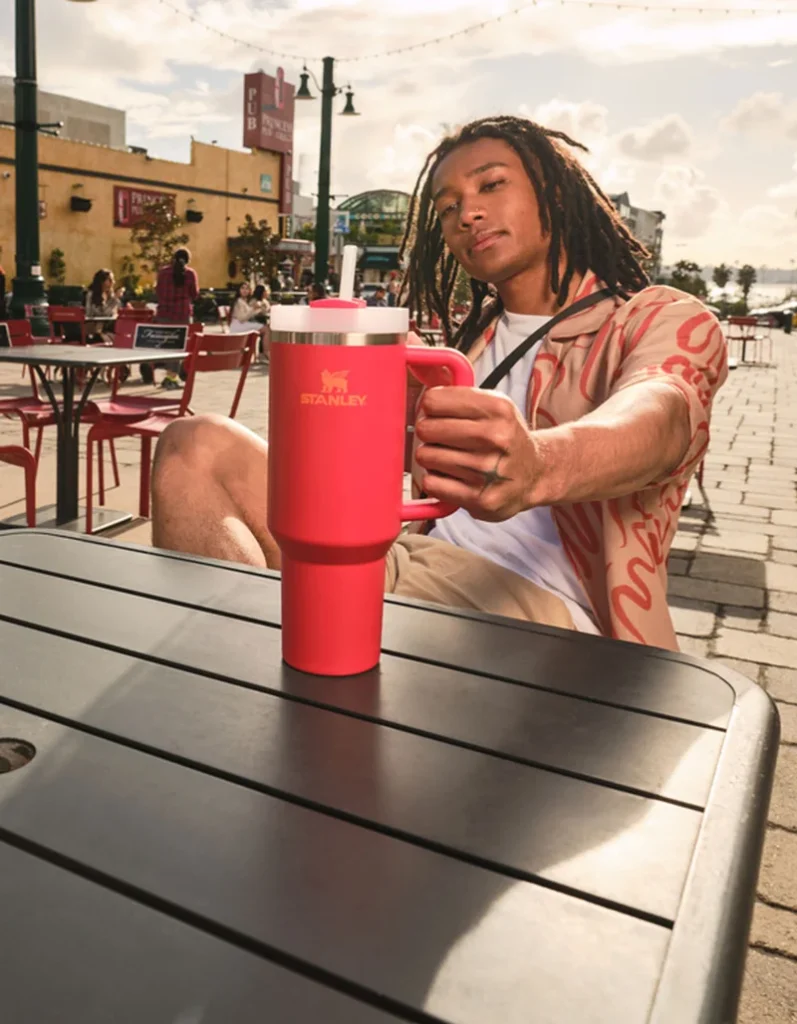 a man sitting at a table with a red cup